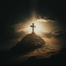 Cross on a rocky hill with light radiating from it