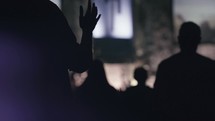 worshipers with raised hands in church 