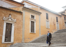 a man walking down steps in Rome 