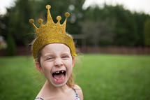 a girl with a crown and missing teeth 