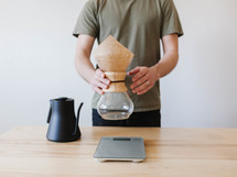 a man slow brewing coffee 