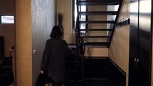 a woman walking up stairs in her home 