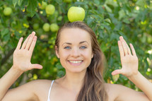 a woman balancing an apple on her head 