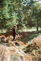a boy playing outdoors in fall 