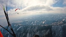 Fly like a bird on paragliding wing in thermal flight above winter forest mountains, Adrenaline extreme sport Freedom