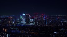 Bishops road in the City of London, aerial shot of the financial district at night. Forwards fly above night town. Illuminated streets and buildings. 