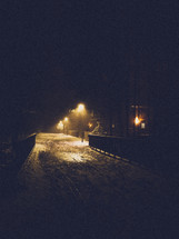 glow of street lamps on snow at night 