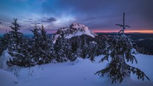 Clouds time lapse in winter mountains with snowy forest trees at sunrise 