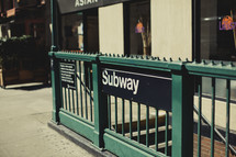 A Subway sign on a New York sidewalk