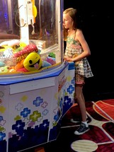 a girl playing in an arcade 