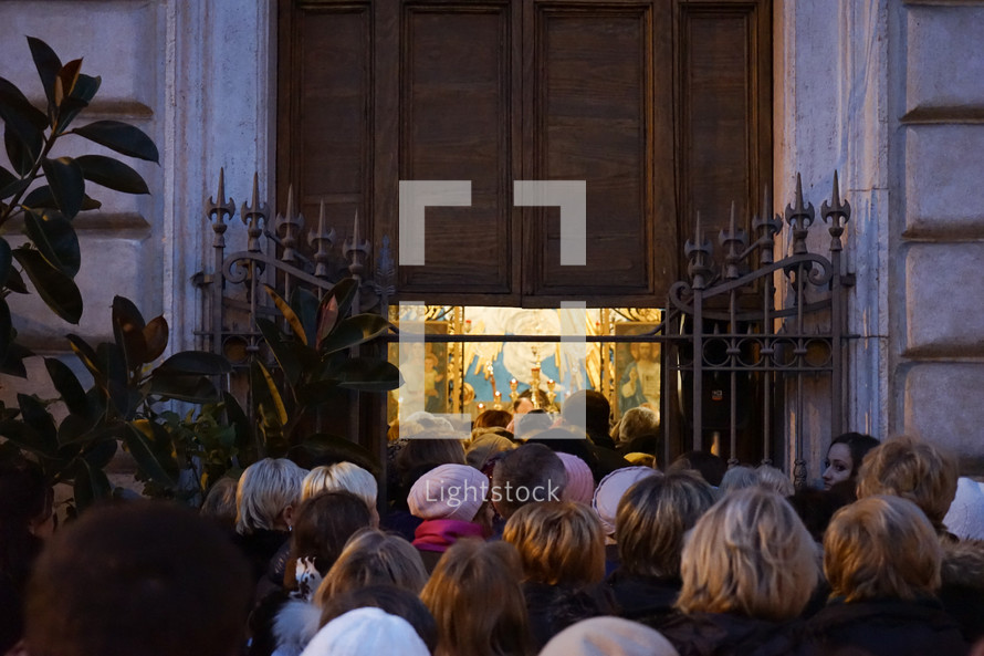 crowds of people entering a Catholic church in Rome 