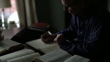 man journaling and reading a Bible 