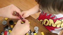 father and son building legos
