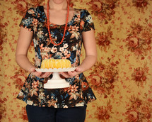 a woman holding a cake 