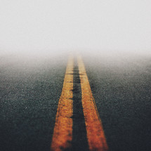 fog over center lines on a road 