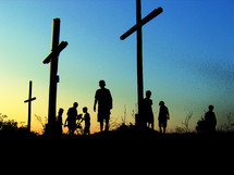 silhouettes of youth around crosses