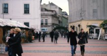 people walking through a town square in Romania 