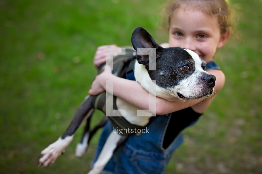 a girl holding her dog 