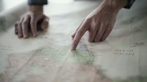 a man looking at a map planning a trip 