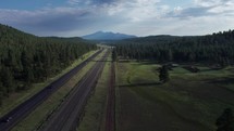 Aerial of a scenic highway heading towards distant mountains