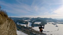 Beauty of free paragliding proximity flying by rocks in winter nature landscape, Extreme sport Adrenaline
