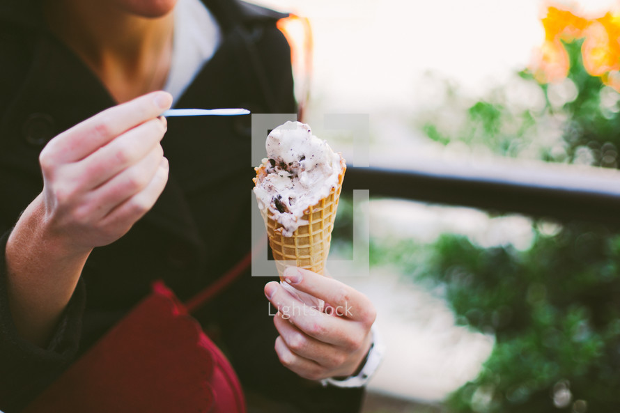 a woman eating a waffle cone 