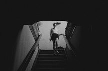 a woman walking down a stair well 