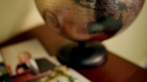 globe and photographs on a table 