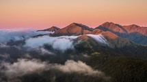 Beautiful evening colors in mountains above misty clouds in New Zealand nature Time lapse
