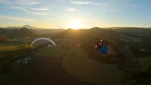 Paragliding adventure flying freedom at golden sunrise in spring nature adrenaline sport
