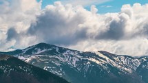 Dramatic clouds sky moving over alps mountains in early spring season Nature time-lapse 

