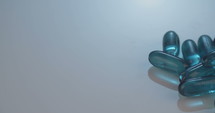 Prescription drugs - Capsules, pills, tablets on reflective background