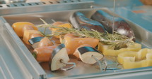 Slow motion shot of vegetables on a grill in an outdoor luxury kitchen.