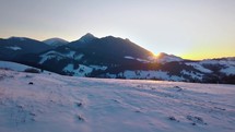 Colorful sunset over alpine mountains in winter landscape
