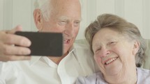 elderly couple taking a selfie 