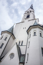 exterior of a church with tall steeple 