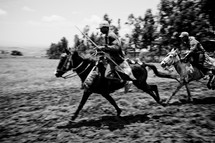men riding horses in Africa 