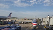 Timelapse of airline jets and equipment on a busy airport ramp