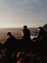 Men sitting at the shore.