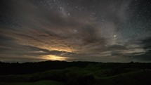 Clouds moving fast in starry night stars milky way sky in summer evening in New Zealand Astronomy Time lapse