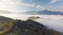 Aerial landing over foggy landscape in colorful autumn morning in rural country
