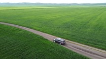 Car driving in field aerial view	