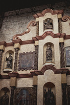 statues and paintings of saints in a cathedral