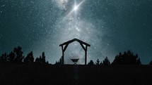 silhouette of a manger under starlight 