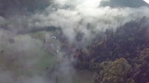 Aerial view of foggy morning in autumn rural country at sunrise

