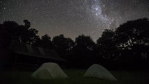 Stars with milky way galaxy over forest camp in starry night sky in New Zealand wild nature landscape Time lapse
