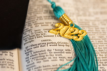 a 2023 graduation tassel on a open Bible