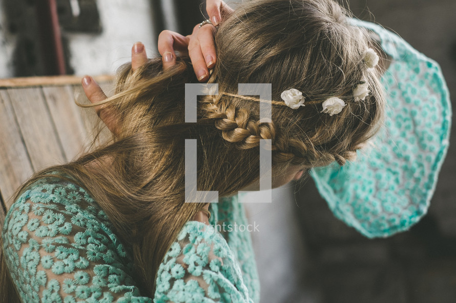woman with braided hair and flowers in her hair 