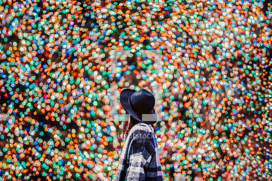 you woman surrounded by colorful bokeh lights
