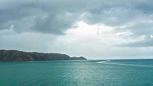 Sailing in blue water of ocean coast in rainy day in New Zealand landscape Time lapse
